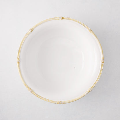 White ceramic serve bowl with a natural edge, 12" diameter, featuring a molded bamboo design.