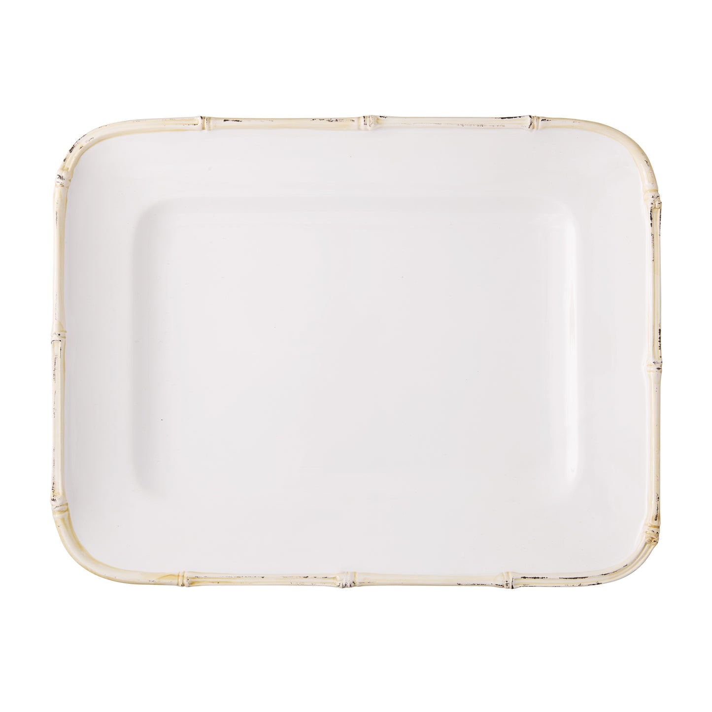 White ceramic rectangular serving platter with a natural-edge bamboo-style rim.