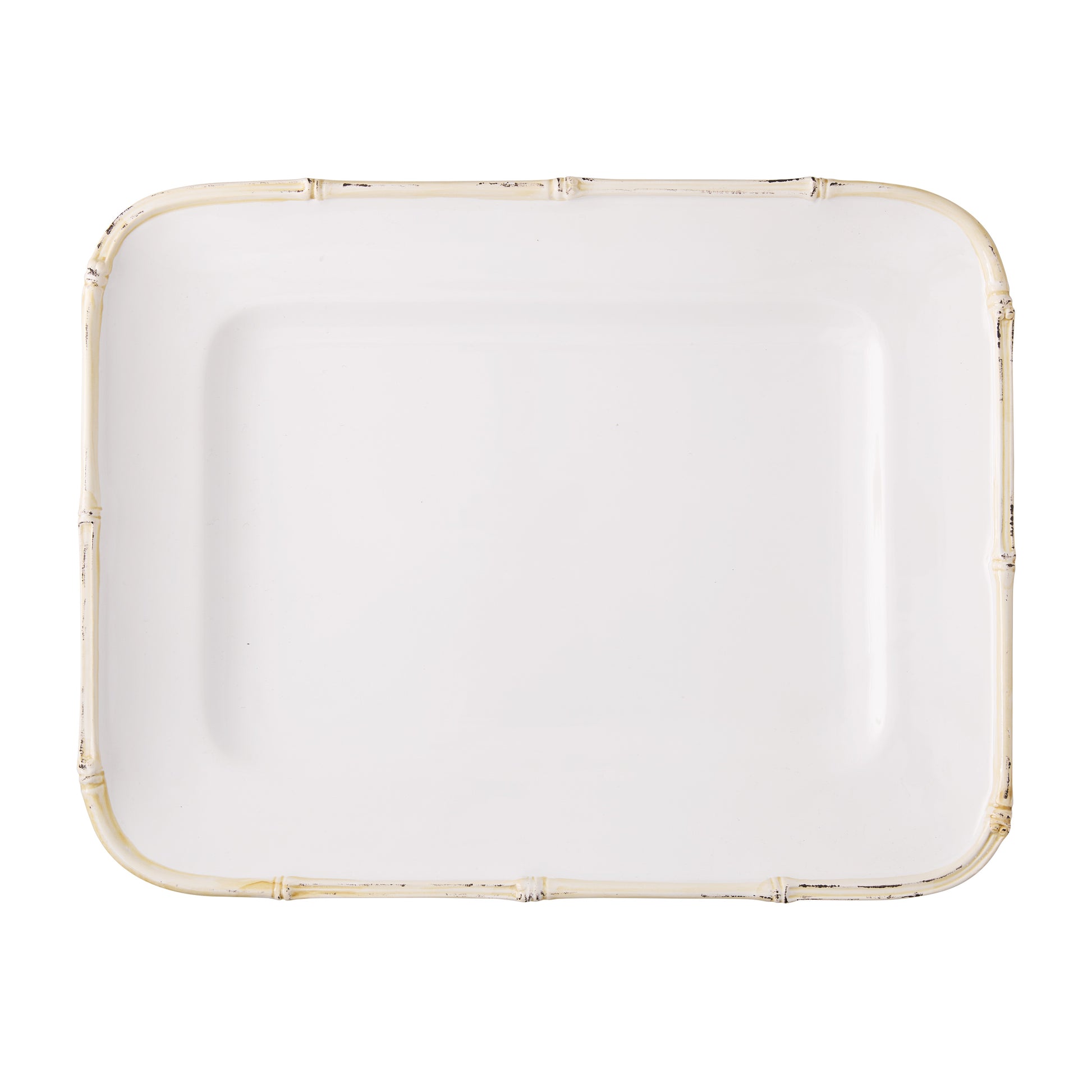 White ceramic rectangular serving platter with a natural-edge bamboo-style rim.