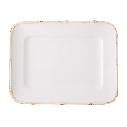 White ceramic rectangular serving platter with a natural-edge bamboo-style rim.