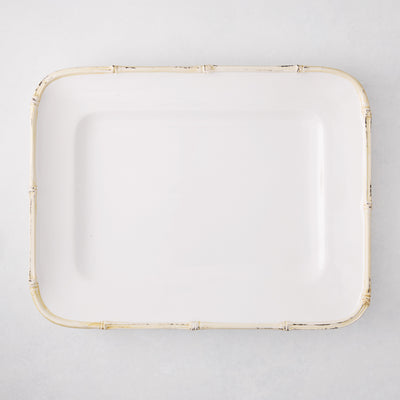 White rectangular ceramic serving platter with a natural-edge bamboo-molded rim.