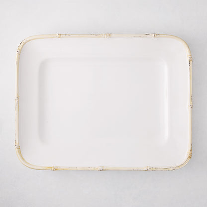 White rectangular ceramic serving platter with a natural-edge bamboo-molded rim.