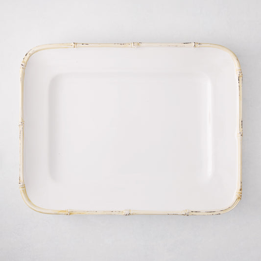 White rectangular ceramic serving platter with a natural-edge bamboo-molded rim.