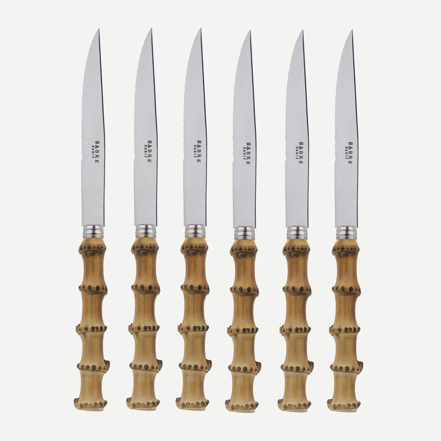 Set of 6 bamboo steak knives with stainless steel blades and varnished wood handles.