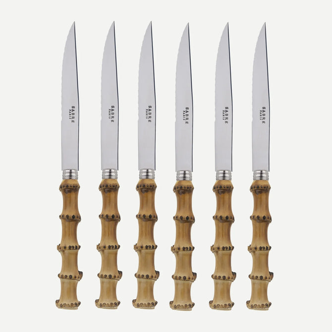 Set of 6 bamboo steak knives with stainless steel blades and varnished wood handles.
