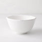 White ceramic cereal bowl with molded bamboo detailing on the rim.