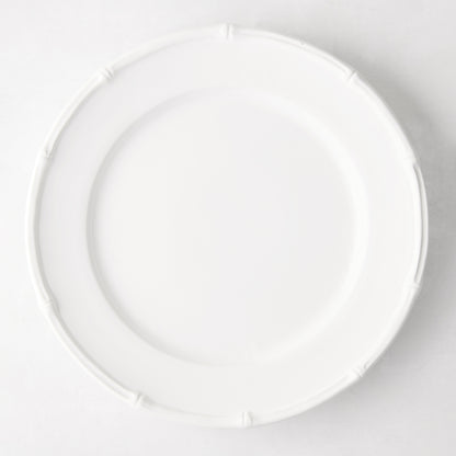 White ceramic 11" dinner plate with a molded bamboo-style rim.