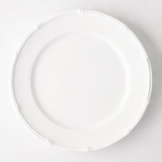 White ceramic 11" dinner plate with a molded bamboo-style rim.