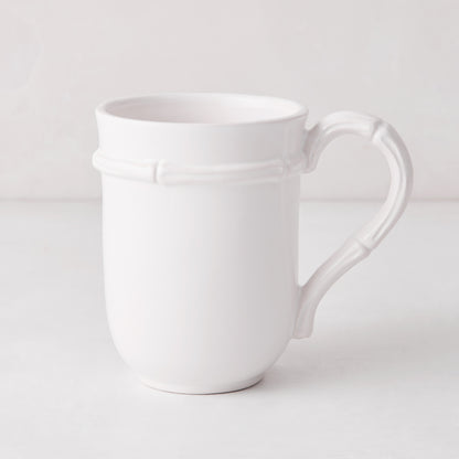 White ceramic mug with molded bamboo detailing on the handle and rim.