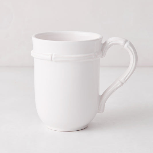 White ceramic mug with molded bamboo detailing on the handle and rim.