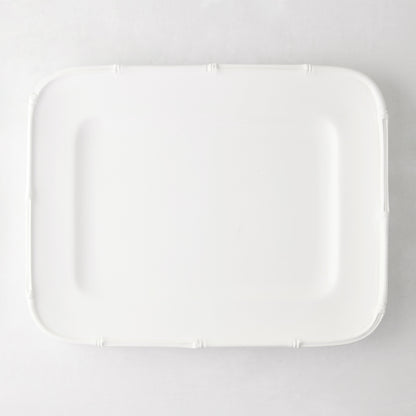 White ceramic rectangular serving platter with bamboo-molded edge.