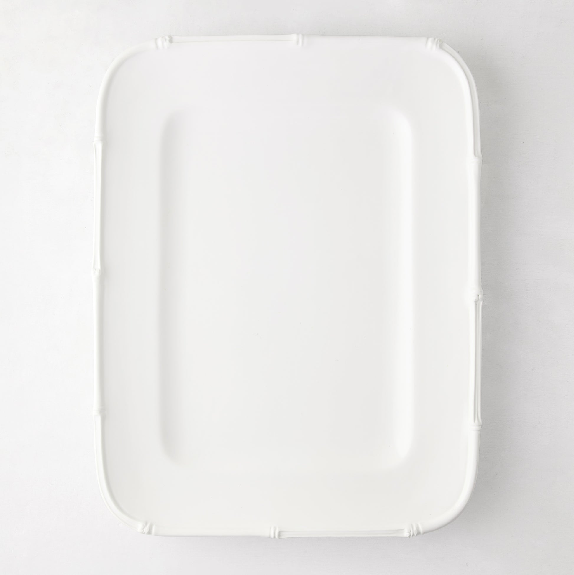 White ceramic rectangular serving platter with a molded bamboo-style edge, 17"L x 13"W.