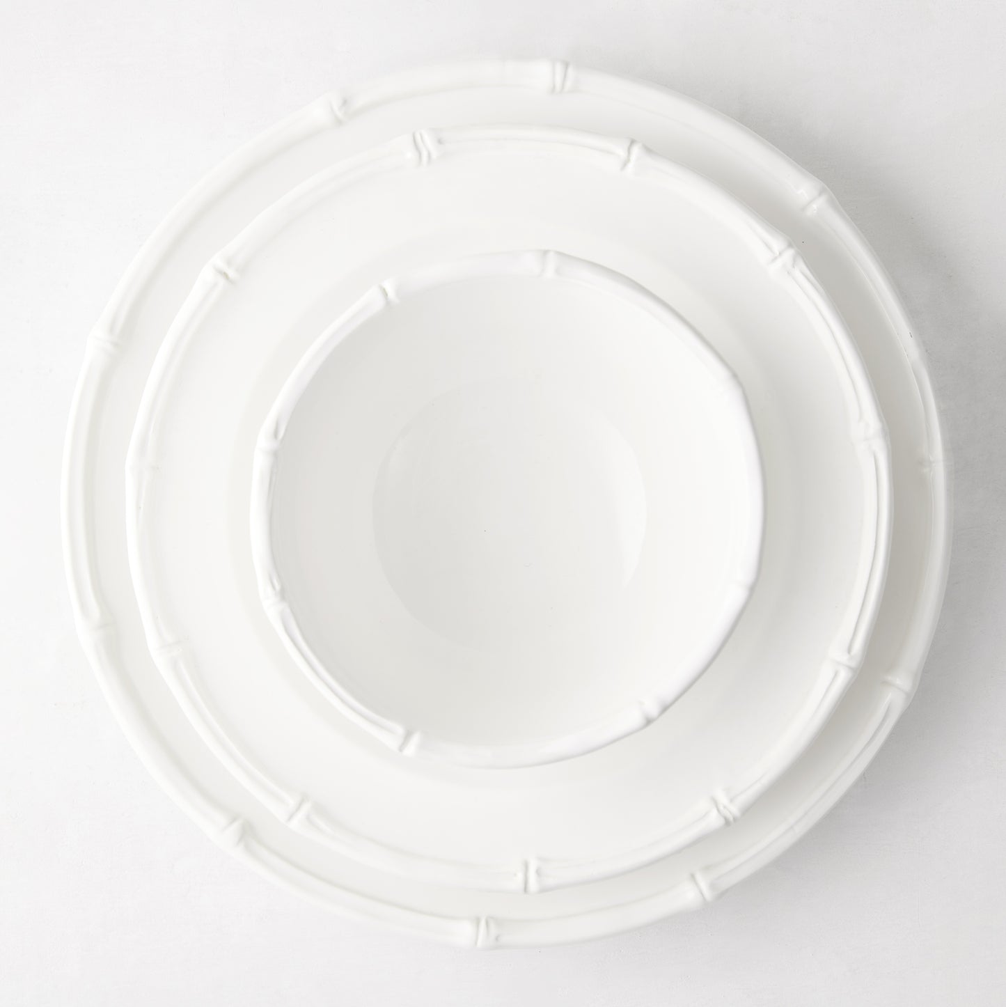 White ceramic salad plate with molded bamboo detailing.