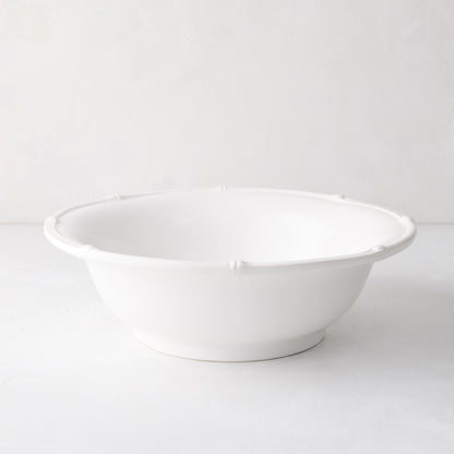 White ceramic serve bowl with molded bamboo detailing, 12" diameter.