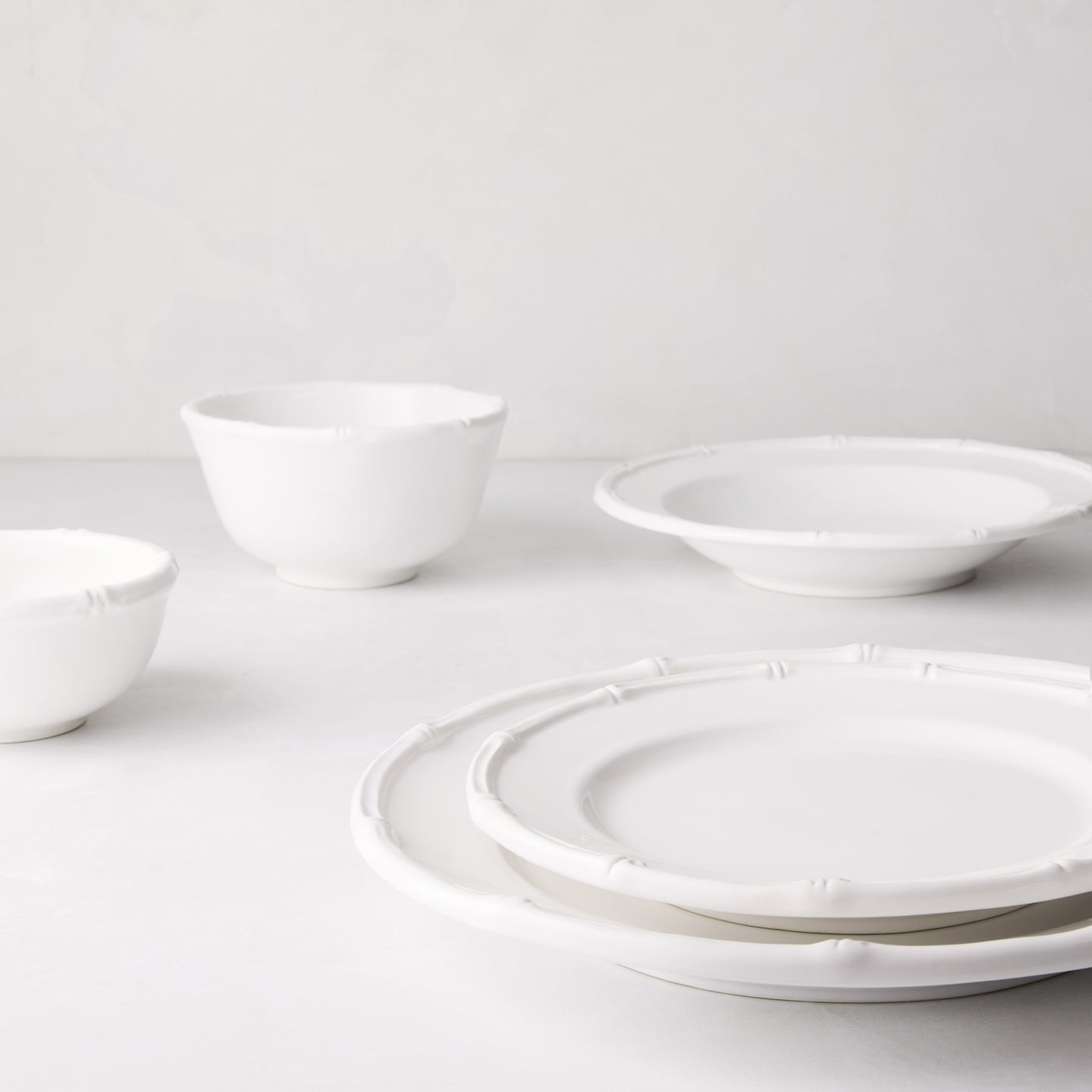 White ceramic soup bowl with molded bamboo detailing, 9.5" diameter.
