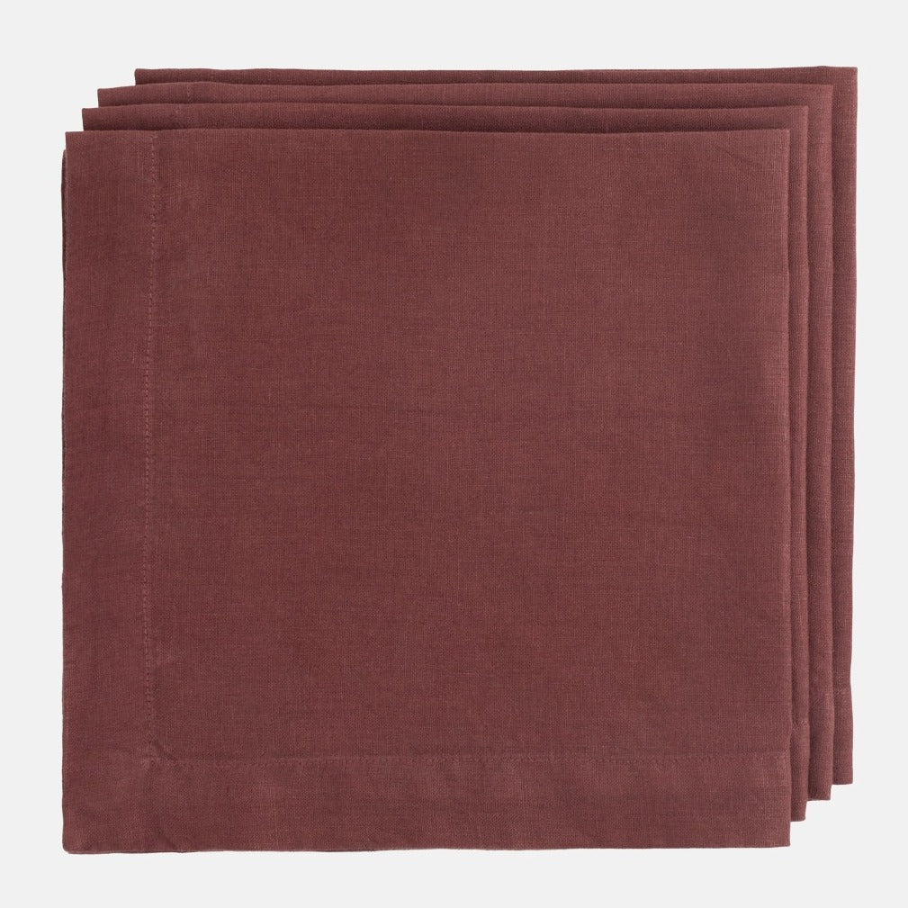 Barnwood HG Signature Hand-dyed Linen Napkin, folded, in a soft, warm maroon color.