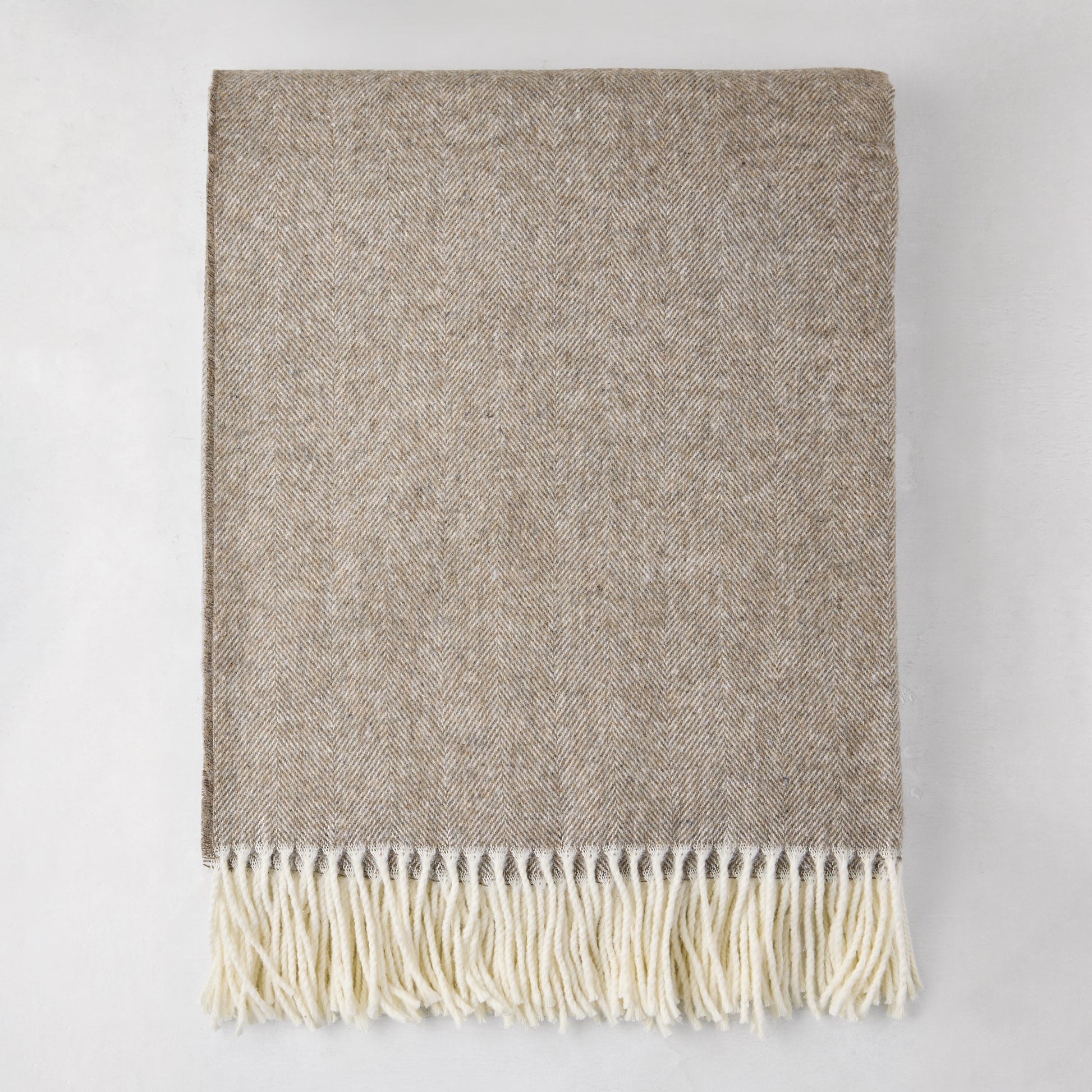 Barnwood Italian Herringbone Throw Blanket, cashmere-soft cotton-acrylic, with decorative fringe.