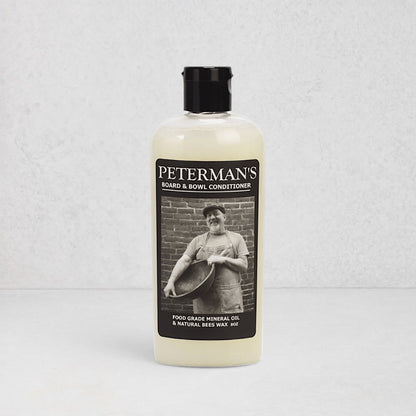 Peterman's 8oz Beeswax Conditioner for Wood Boards & Bowls, light bottle with black label featuring a man.