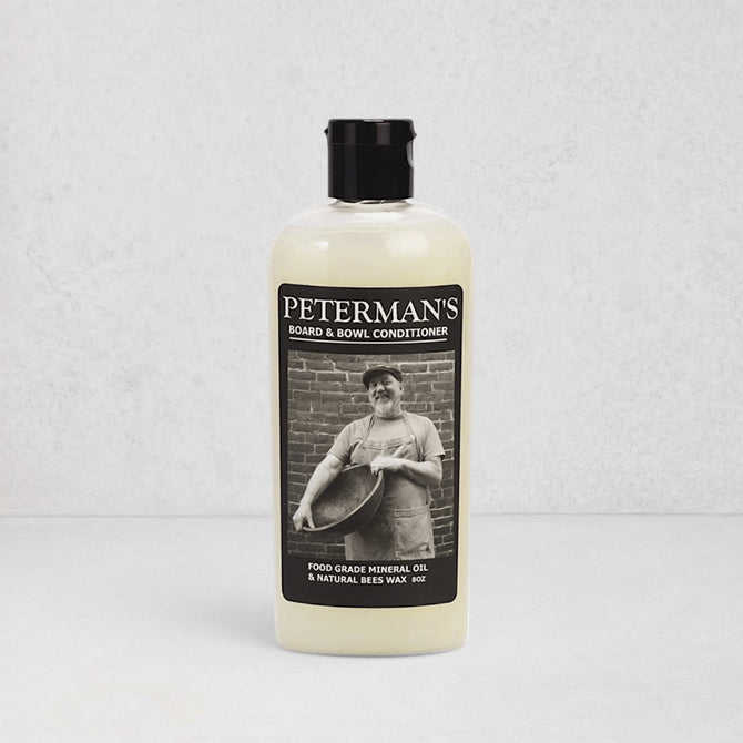 Peterman's 8oz Beeswax Conditioner for Wood Boards & Bowls, light bottle with black label featuring a man.