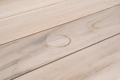 Close-up of Big Sur Dining Table, showing light-colored solid teak wood slats with a circular plug.
