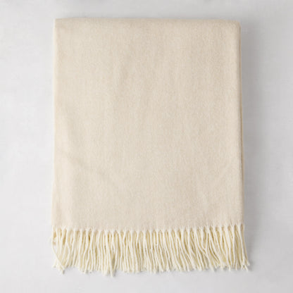 Birch off-white Italian herringbone throw blanket, folded, with fringe.