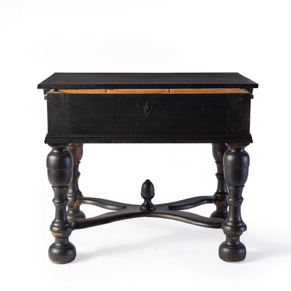 Black ebonized wood console table with carved legs, cross supports, and a central decorative knob.