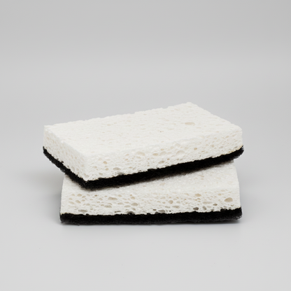 Set of 2 rectangular black and white kitchen scourer sponges with textured white top and black base.