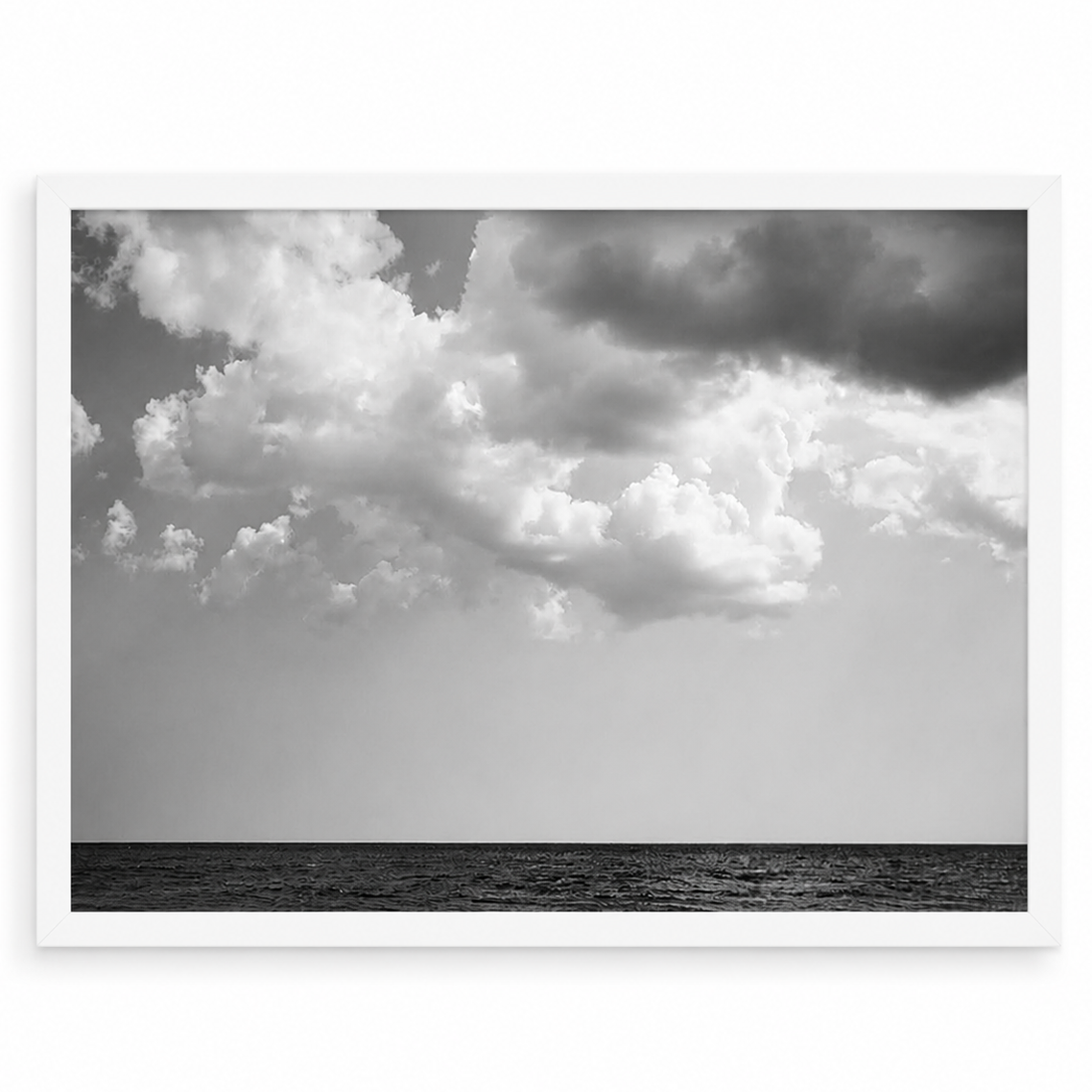 Black and white ocean photograph by Matt Albiani, featuring dark water and dramatic clouds in a white frame.