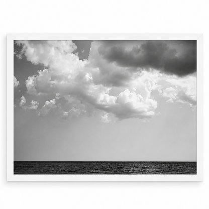 Black and white ocean photograph by Matt Albiani, featuring dark water and dramatic clouds in a white frame.