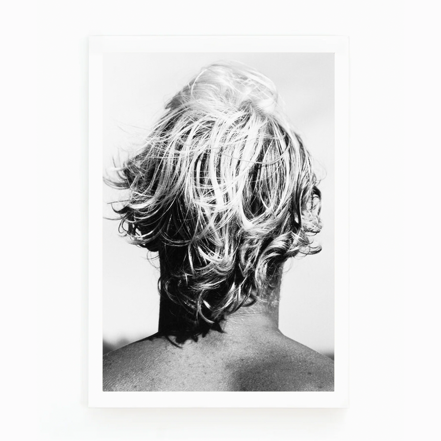 Black and white photograph by Matt Albiani showing the back of a surfer's head with messy, light hair.