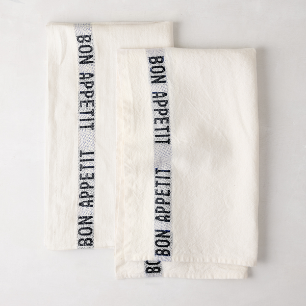 Set of 2 white linen "Bon Appetit" hand towels with black embroidered text and blue striped detail.