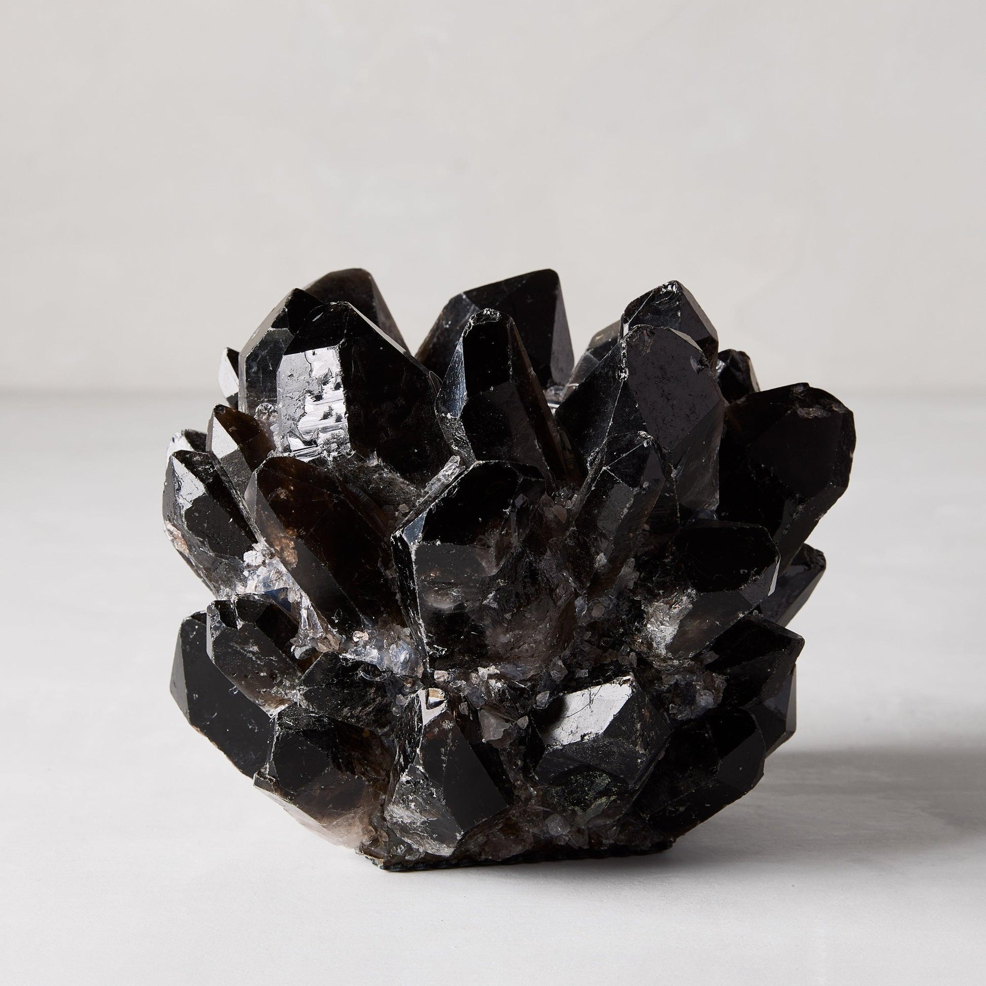 Black genuine quartz crystal votive candle holder, 6.5"Dia x 5.5"H, with raw, unrefined elegance.
