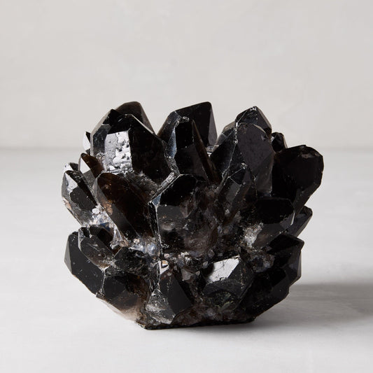 Black genuine quartz crystal votive candle holder, 6.5"Dia x 5.5"H, with raw, unrefined elegance.