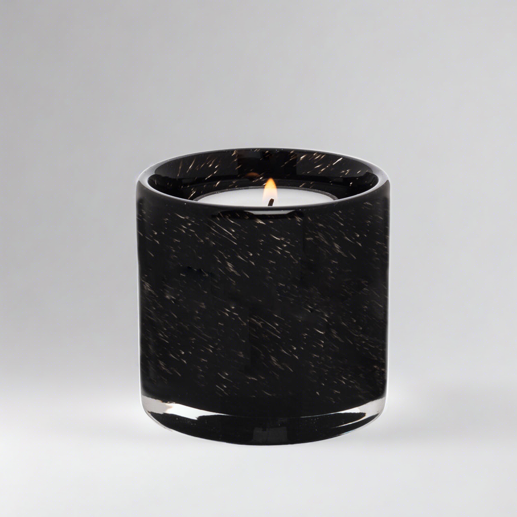 Black mouth-blown glass votive candle holder with a lit tealight, 2.75-inch cylindrical design.