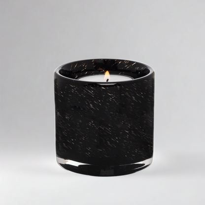 Black mouth-blown glass votive candle holder with a lit tealight, 2.75-inch cylindrical design.