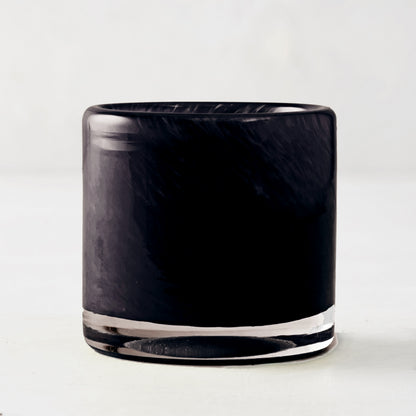 Mouth-blown black glass votive candle holder with a smooth, cylindrical design, 2.75 inches tall.