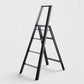 Hudson Grace black Hasegawa Lucano 4-step ladder with a minimalist matte finish, safety bar, and grooved treads.