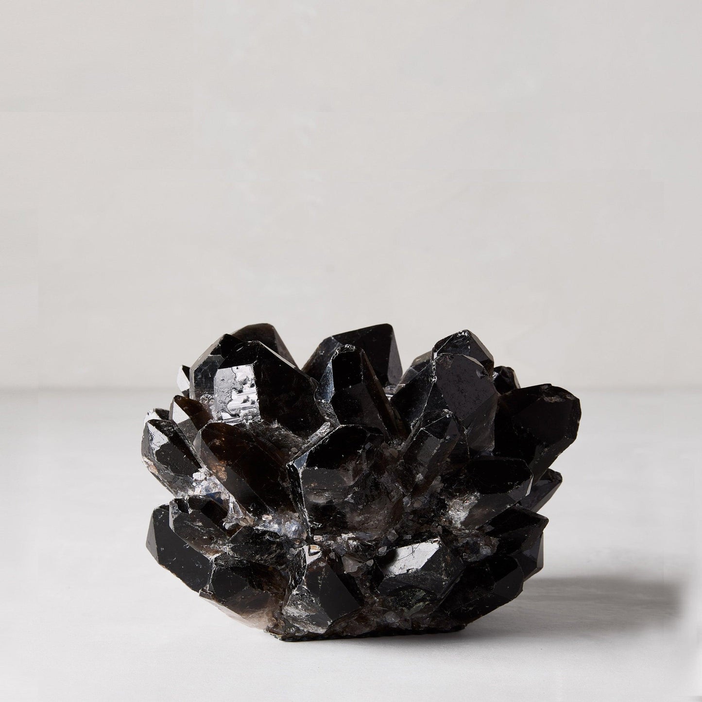 Black petite quartz votive candle holder, 5"Dia x 3"H, made from genuine dark quartz crystals.