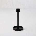 Black metal tear-off cocktail napkin holder, 5"H, with a round base and top.