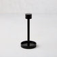 Black metal tear-off cocktail napkin holder, 5"H, with a round base and top.