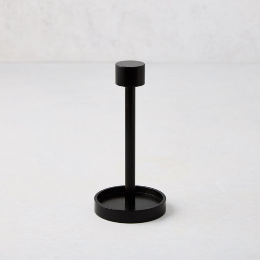 Black metal tear-off cocktail napkin holder, 5"H, with a round base and top.
