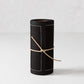 Black cotton cocktail napkin roll with white dotted border, tied with twine.