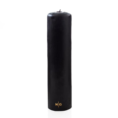 HG Black Unscented Pillar Candle, 3"x12", with gold HG logo, on a white background.