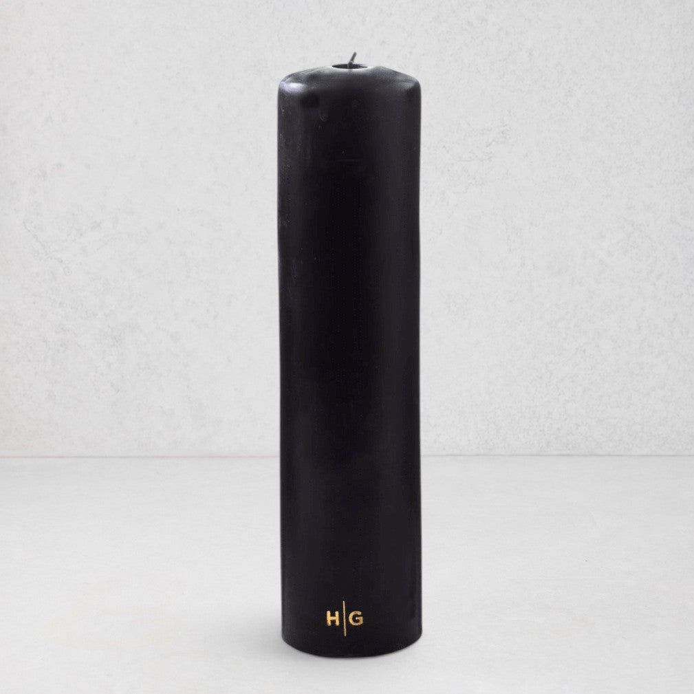 HG Black Unscented Pillar Candle, 3"x12", with gold HG logo and oversized cotton wick.