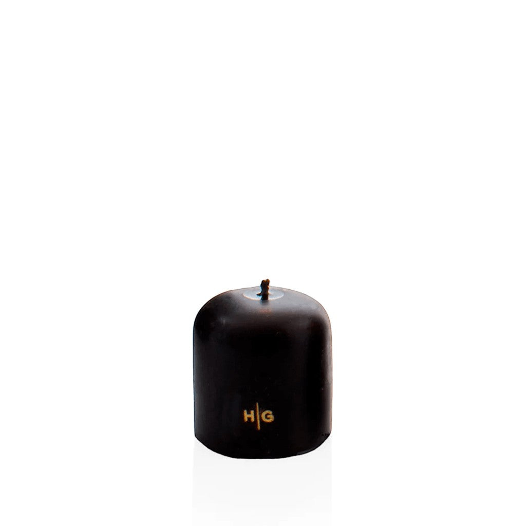 HG Black 3"x3" unscented pillar candle with gold HG logo and oversized cotton wick.