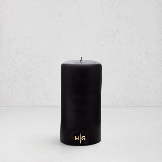 HG Black Unscented Pillar Candle, 3"x6", with a gold embossed HG logo.