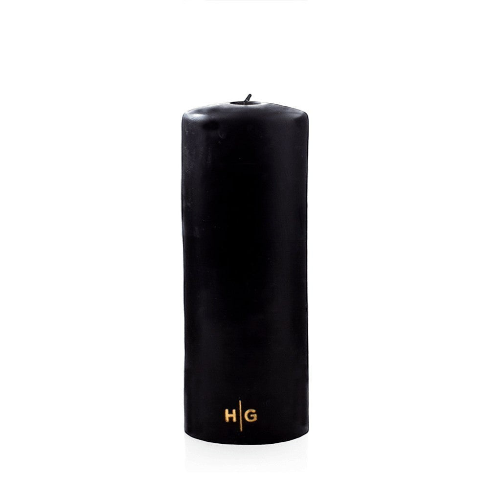 Hudson Grace black unscented pillar candle with gold HG logo, hand-dipped paraffin and amber resin, 3 by 8 inches.