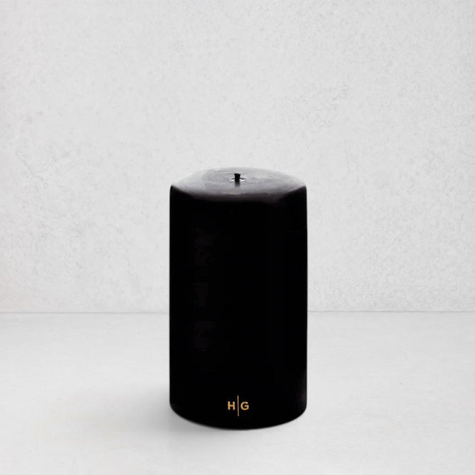 HG Black Unscented Pillar Candle, 4"x6", with gold HG logo.