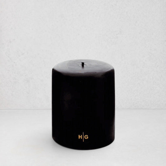 HG Black Unscented Pillar Candle, 5"x6", with gold HG logo and oversized cotton wick.