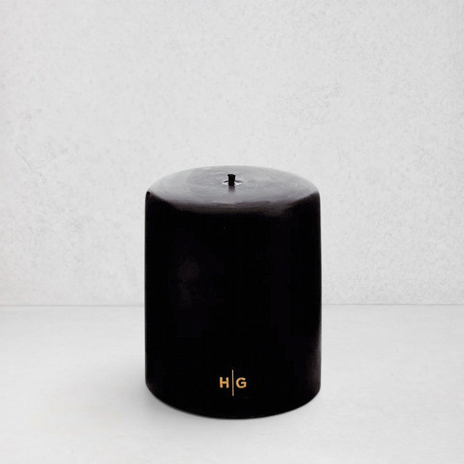 HG Black Unscented Pillar Candle, 5"x6", with gold HG logo and oversized cotton wick.